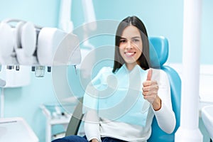 A young girl at a reception with a dentist in a chair