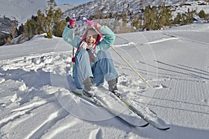 Young girl recover with fun after the fall when skiing photo