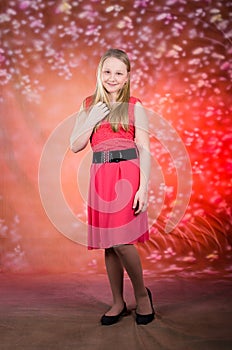 Young girl in red dress pose in studio