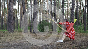 Young girl in red dress shooting from a sitting position