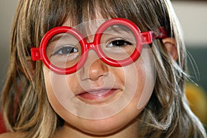 Young girl with red glasses