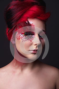 Young girl with red hair and creative ingenious makeup