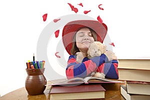 Young girl with red hat loving her teddy bear isolated