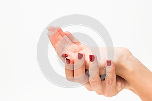 Young girl with red manicure holding hand