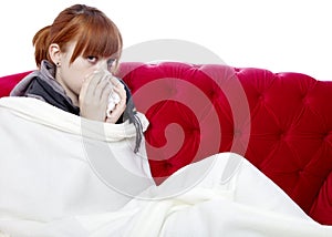 Young girl on red sofa is sick