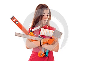 A young girl in a red t-shirt with the surprised face holding a measuring instruments isolated on white background