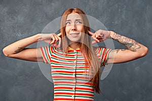 Young girl refuses to listen something unpleasant.