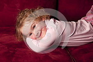 Young girl relaxing and smiling on couch