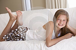 Young Girl Relaxing On Sofa At Home