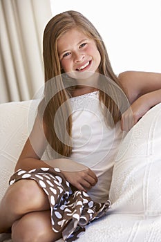 Young Girl Relaxing On Sofa At Home