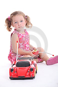 Young girl with remote-control car