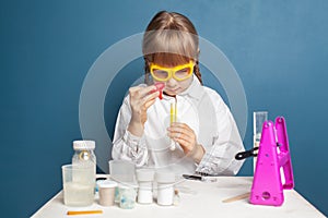 Young girl researcher experimenting with substances. Science and education concept