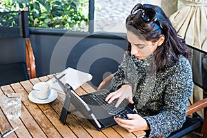 Young girl researching on tablet and smartphone