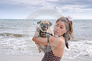 Young girl is resting with a dog on sea.