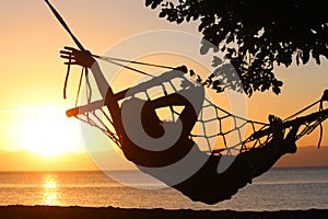 Young girl resting in a hammock overlooking the sea