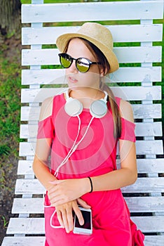 young girl resting on a wooden chair in the garden