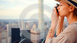 Young girl with a retro camera on the roof