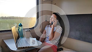 A young girl rides a train.