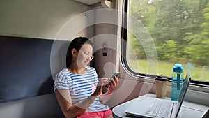 A young girl rides a train.