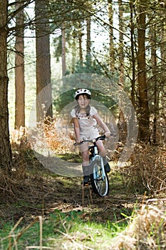 Young Girl Riding her Bike in the Forest