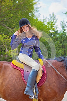 Young girl riding a horse.