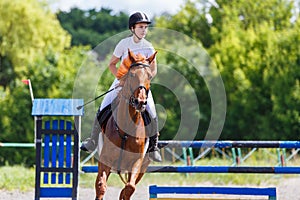 Young girl riding horse on equestrian sport show