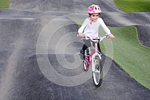 Young Girl Rids Bicycle on Obstacle Trek