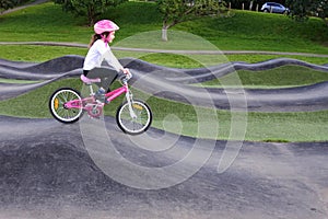 Young Girl Rids Bicycle on Obstacle Trek