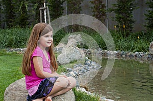 Young Girl on Rock by Calm Stream