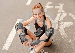 Young girl in rollerblades on bicycle lane