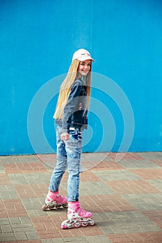 Young girl on rollerblades in the city