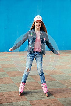 Young girl on rollerblades in the city