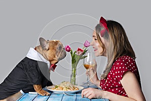 Young girl on romantic valentine`s day date with her dog french bulldog