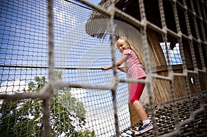 Young girl on rope ladder