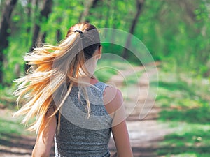 Young girl running at the forest happy