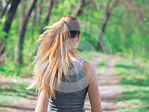 Young girl running at the forest happy