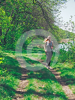 Young girl running at the forest happy