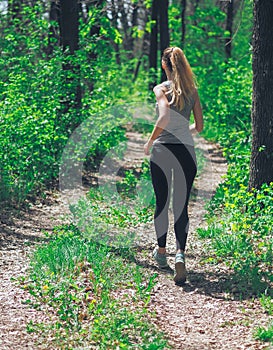 Young girl running at the forest happy