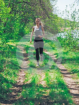 Young girl running at the forest happy