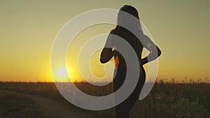 young girl runs across field sunset headphones. silhouette girl rays sunlight listens music. healthy image women health
