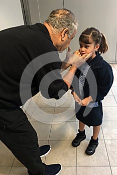 Young girl is sad that her grandfather is leaving after a visit