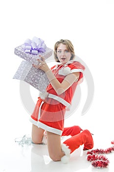Young girl in Santa Claus clothes with gift box