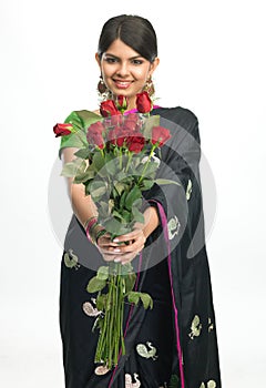 Young girl in sari with red roses