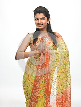 Young girl in sari in a welcome posture