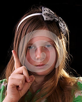 Young girl scolding and waving her finger