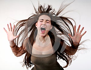 Young girl screaming with flying hair