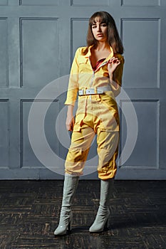 A young girl seductress in a yellow unbuttoned clothes photo