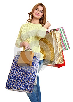Young girl with shopping bag casual dressed blue jeans and a green sweater posing in studio on white background