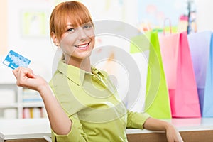 Young girl shopping with her credit card and colourful bags
