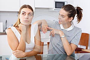 Young girl showing betrothal ring to upset female friend